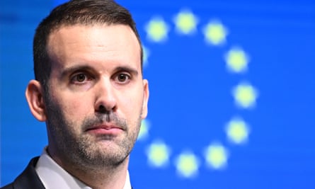 A headshot of the Milo Spajić in front of background featuring the blue and yellow stars of of the EU flag
