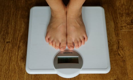 The feet of a person being weighed on scales