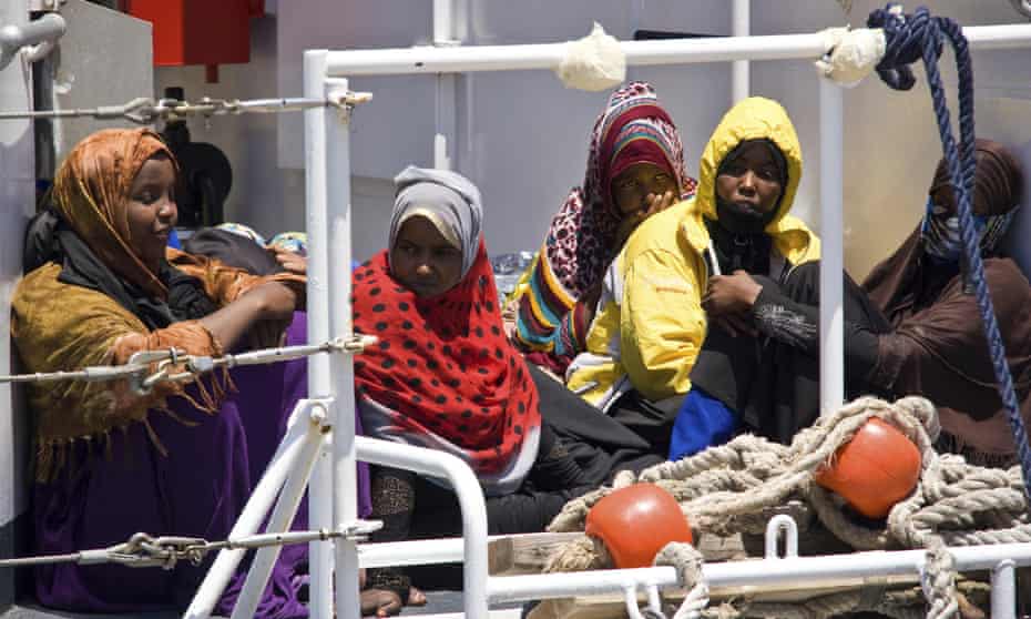 Migrants wait to disembark from a ship in Lampedusa, Italy, after they were rescued at sea.