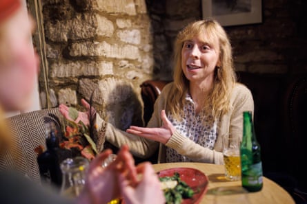 Tamsin sitting at a restaurant table chatting and gesticulating