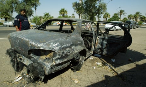A burnt car at the site where Blackwater guards opened fire on a crowd in Baghdad, Iraq, in 2007. Donald Trump has pardoned the four contractors jailed over the killing of 14 civilians.