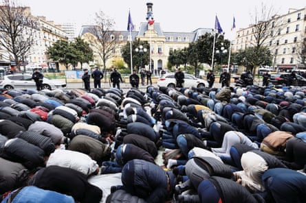 French protest … Muslim men pray in the street after their mosque is closed in Clichy in March 2017.