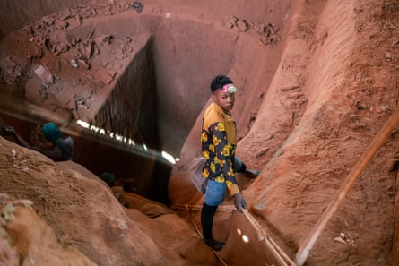Aerial image of a man standing over a pit