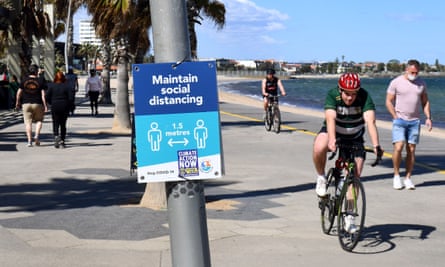 People exercise along the St Kilda beach foreshore in Melbourne