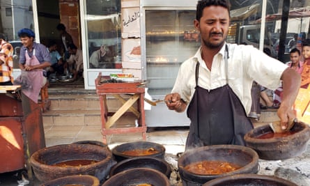 A Yemeni vendor prepares food at an outdoor restaurant in of al-Hudaydah.