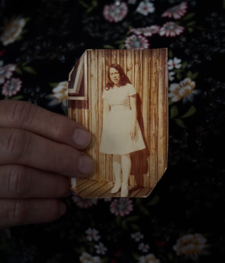 An old, slightly faded, photograph of a girl in a dress