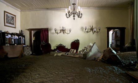 Sludge fills a living room after the overflowing of the Estero San Jose River in San Alfonso, Santiago.