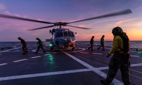 A seahawk helicopter prepares to take off from the deck of HMAS Hobart.