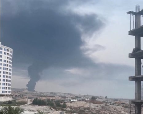 A plume of smoke rises from Qeshm, Iran, on Thursday after reported strikes in a screengrab from social media video