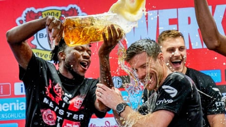 Bayer Leverkusen players shower Xabi Alonso in beer during press conference – video