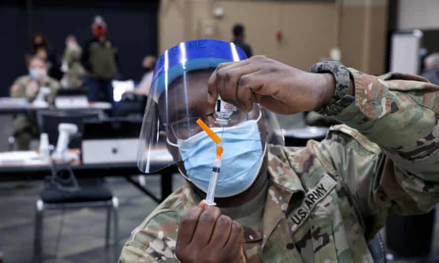 Sgt Derrick Ngbome of the Illinois army national guard prepares a Covid-19 vaccine at the Tinley Park Convention Center in Tinley Park, Illinois, near Chicago.