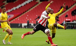 Fulham's Tosin Adarabioyo looks to block a shot from David McGoldrick of Sheffield United