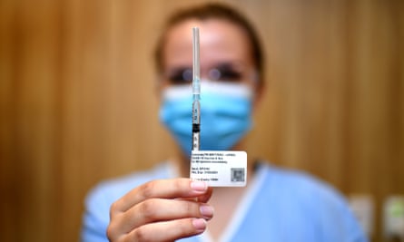 A nurse holds up a syringe containing the Pfizer vaccine in Brisbane
