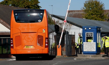 A bus carrying a group of people thought to be migrants arrives at the Manston immigration holding facility in Thanet, Kent