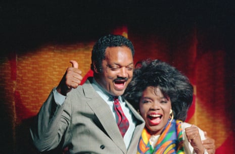 Jesse Jackson gives a “thumbs up” sign as he enjoys his appearance on stage with an equally happy Oprah Winfrey at a salute for Jackson at a downtown Atlanta theater in 1984.