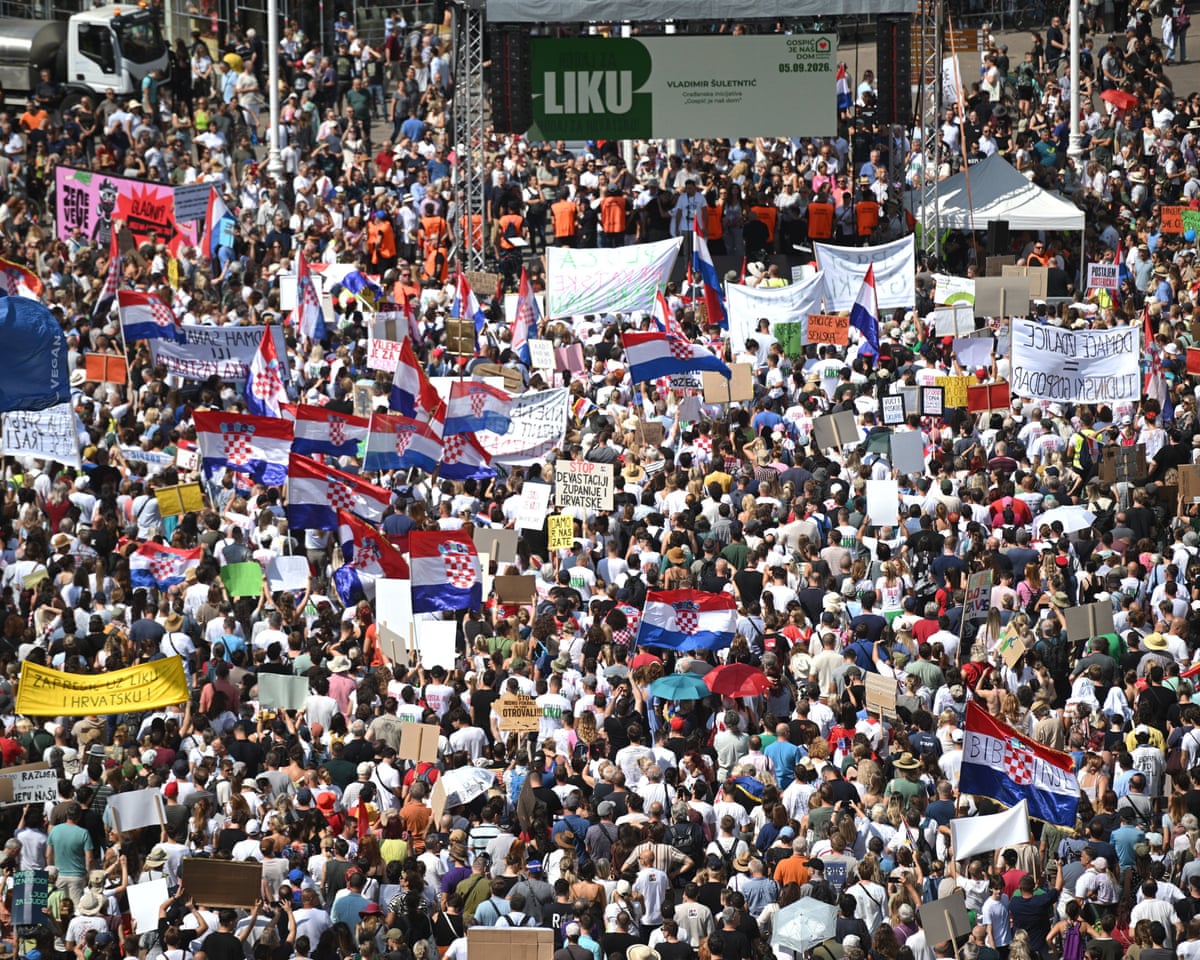 A large group of protesters, some waving the national flag of Croatia.