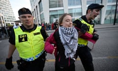 Climate activist Greta Thunberg is removed from a protest outside the arena