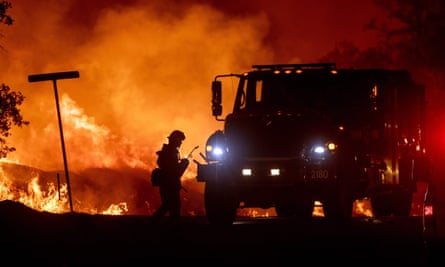 A firefighter lights backfires during the Carr fire in Redding, California.