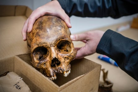 Graduate student Chloe McDaneld holds the skull of an unidentified migrant at the Operation Identification facility in December. Photo by Gabriela Campos