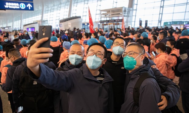Medics pose for a photo prior to departure from Wuhan International Airport.