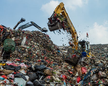 Waste pickers hunt for recyclable materials alongside dense machinery astatine nan Bantar Gebang landfill
