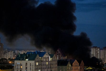 Black smoke rises above apartment blocks after a Russian ballistic missile strike
