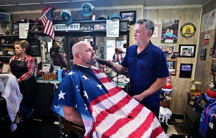Person shaves man in barbershop