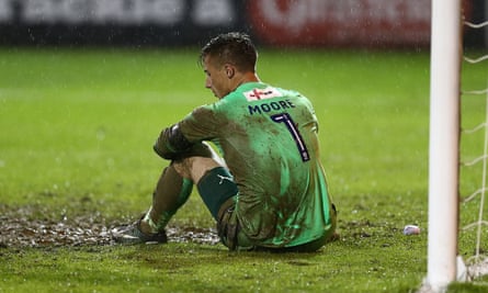 Luton goalkeeper Stuart Moore is inconsolable after his last-gasp own goal handed Blackpool a place in the play-off final.