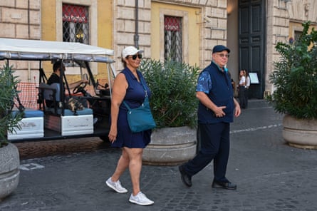 Barry and Linda walking away from a golf cart