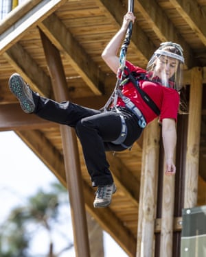 A woman abseiling in an anti-Covid face visor.