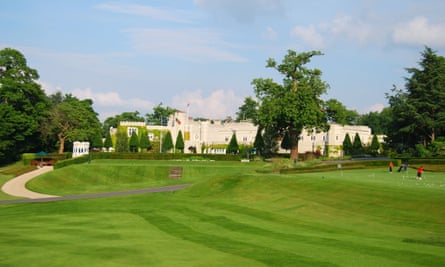 Beautiful lawns surround a large elegant stucco building