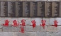Red hand graffiti is seen on the wall outside the Holocaust memorial in Pari, on May 14, 2024, after the monument was vandalised overnight.