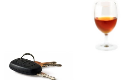 Car key and glass filled with alcohol