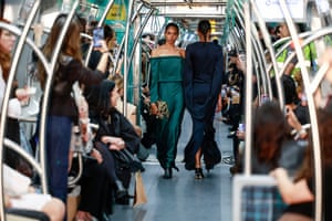 Models present creations by Gloria Coelho on a subway train