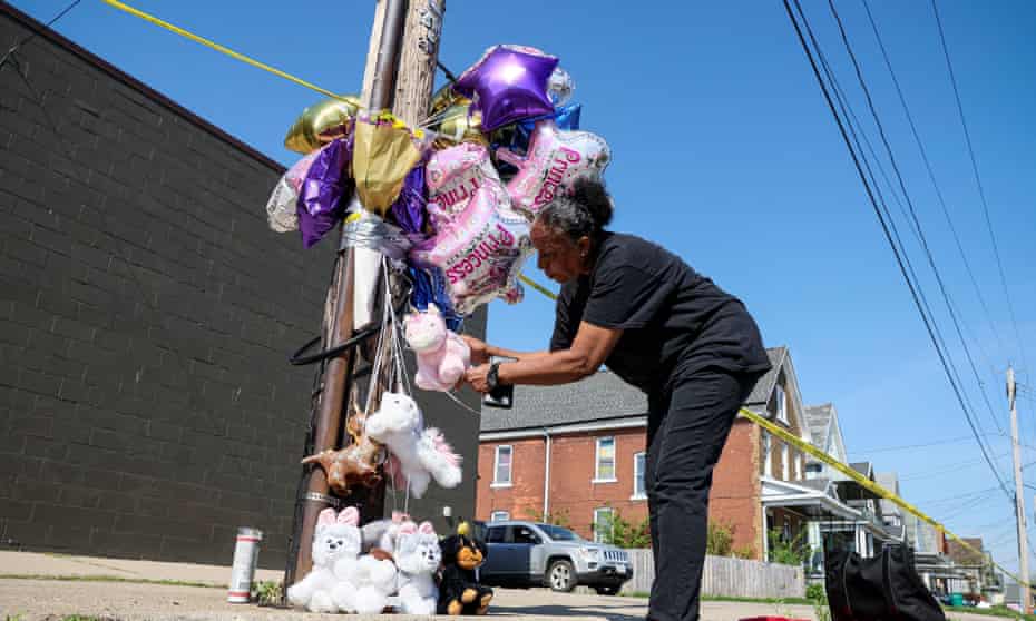 Scene of a shooting at a TOPS supermarket in Buffalo, New York<br>A woman leaves tributes at a memorial for victims near the scene of a shooting at a TOPS supermarket in Buffalo, New York, U.S. May 15, 2022. REUTERS/Brendan McDermid