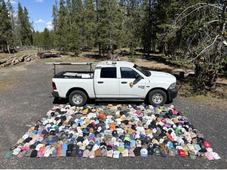 hats are assembled on the ground next to a pickup truck
