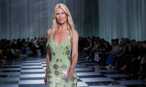 Claudia Schiffer wears a green and silver dress 
at the Versace women's spring/summer 2024 show.