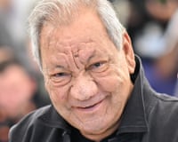 Tony Gatlif smiles in close-up, wearing a dark jacket at a film festival photocall