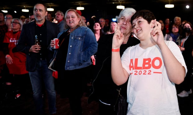Supporters react to updates on the vote count while they wait for the Labor leader Anthony Albanese in Sydney. 