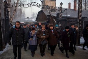 Survivors walk in the former Nazi German concentration and extermination camp Auschwitz-Birkenau