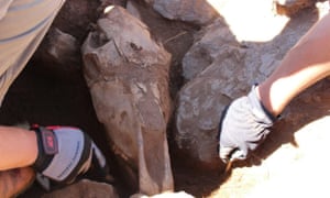 Archaeologists excavate the skull of a 3,000-year-old domestic horse, buried next to a deer stone as part of a ritual sacrifice by early nomadic horsemen.