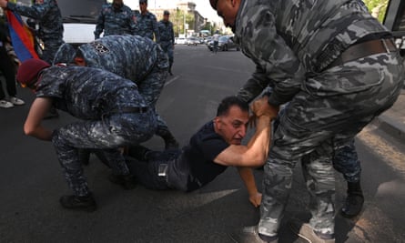 Police detain a protester during a rally against land transfer to Azerbaijan in Yerevan on Saturday.