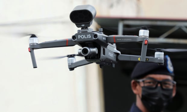 A police officer operates a drone to inspect the area under enhanced lockdown, amid the coronavirus disease (COVID-19) outbreak in Banting, Malaysia October 28, 2020.