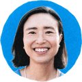 woman smiling against blue background