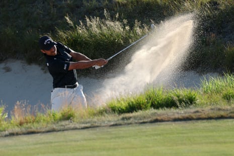 Xander Schauffele shoots out of the bunker on the 12th.