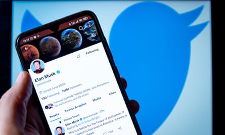 musk’s twitter profile on a phone over the twitter logo