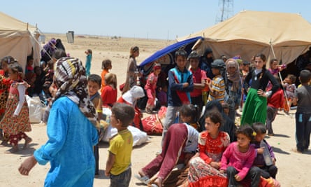Civilians who fled their homes gather on the outskirts of Falluja last week