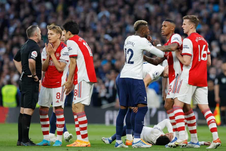 Martin Odegaard and Takehiro Tomiyasu of Arsenal plead with referee Paul Tierney after he sends off Rob Holding as Arsenal’s Gabriel (second right) argues with Tottenham Hotspur’s Emerson Royal (third right).