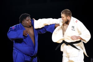 Kody Andrews of New Zealand (right) faces Sebastian Perrinne of Mauritius in the judo.