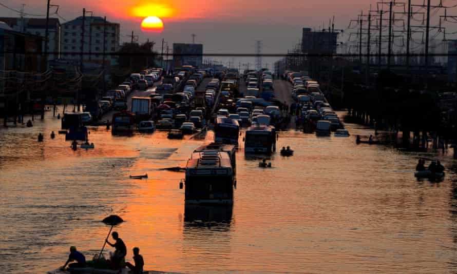 Flood victims make their way through the high waters along the flooded streets in Rangsit, on the outskirts of Bangkok, in 2011.